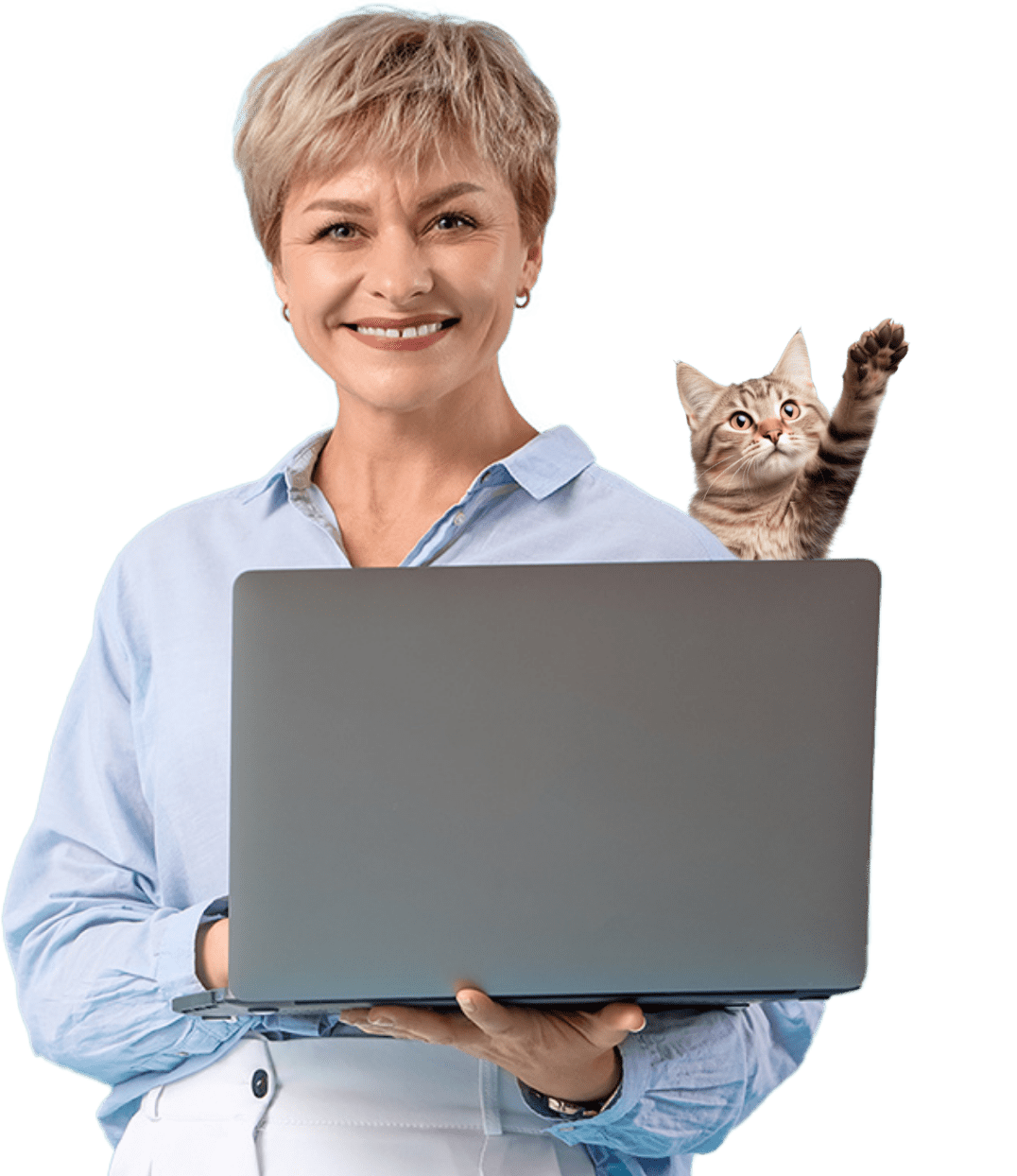 Une femme souriante tenant un ordinateur portable se tient devant un fond clair, tandis qu'un chat tabby se cache derrière l'ordinateur et lève une patte vers le haut.